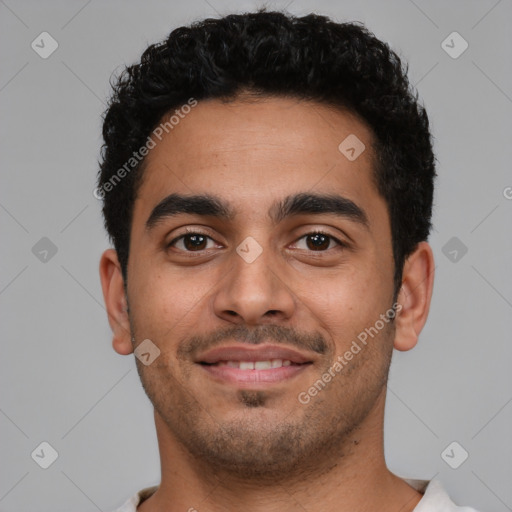 Joyful latino young-adult male with short  black hair and brown eyes