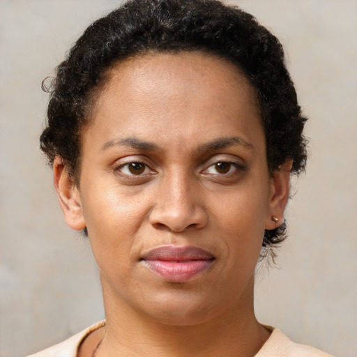 Joyful black adult female with short  brown hair and brown eyes
