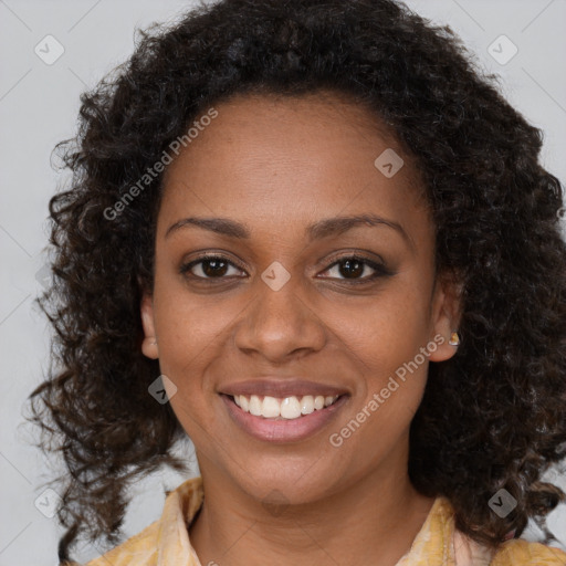 Joyful black young-adult female with long  brown hair and brown eyes