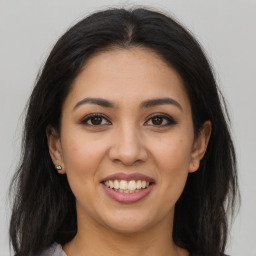 Joyful latino young-adult female with long  brown hair and brown eyes