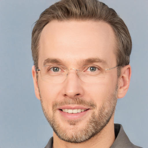 Joyful white adult male with short  brown hair and grey eyes