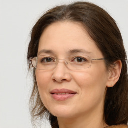 Joyful white adult female with medium  brown hair and brown eyes