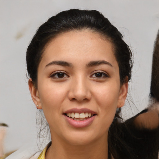 Joyful latino young-adult female with medium  brown hair and brown eyes