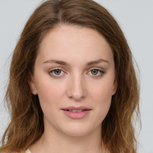 Joyful white young-adult female with long  brown hair and green eyes