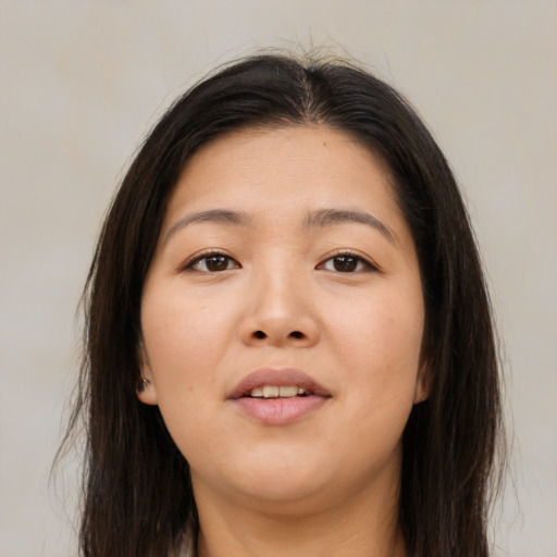 Joyful asian young-adult female with long  brown hair and brown eyes