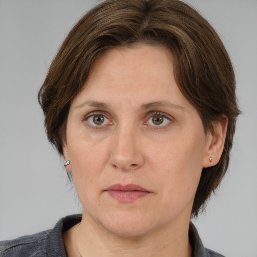 Joyful white adult female with medium  brown hair and grey eyes