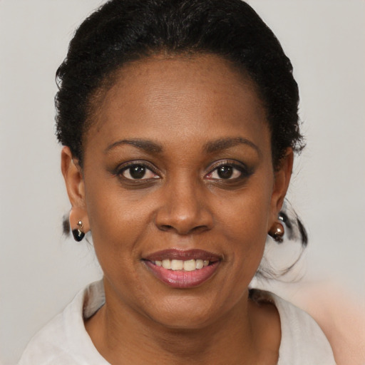 Joyful black young-adult female with short  brown hair and brown eyes