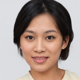 Joyful asian young-adult female with medium  black hair and brown eyes