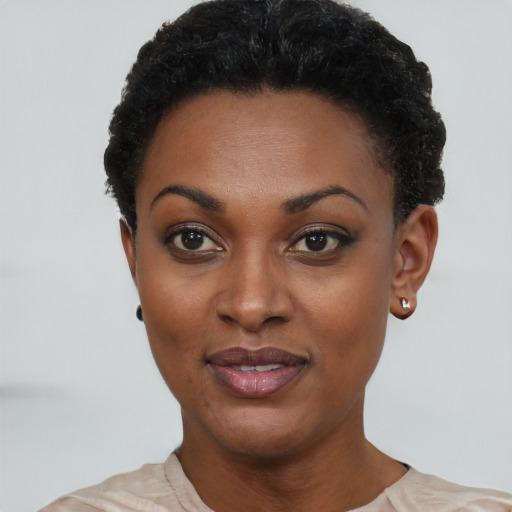 Joyful black young-adult female with short  black hair and brown eyes
