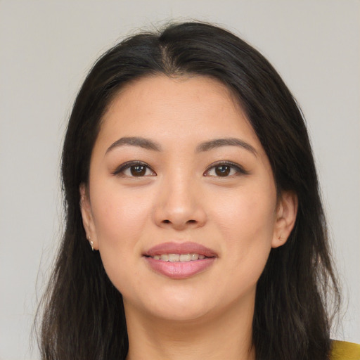 Joyful asian young-adult female with long  brown hair and brown eyes
