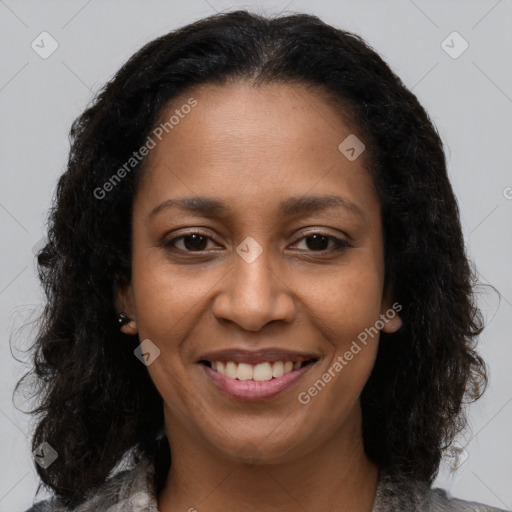 Joyful black young-adult female with long  brown hair and brown eyes