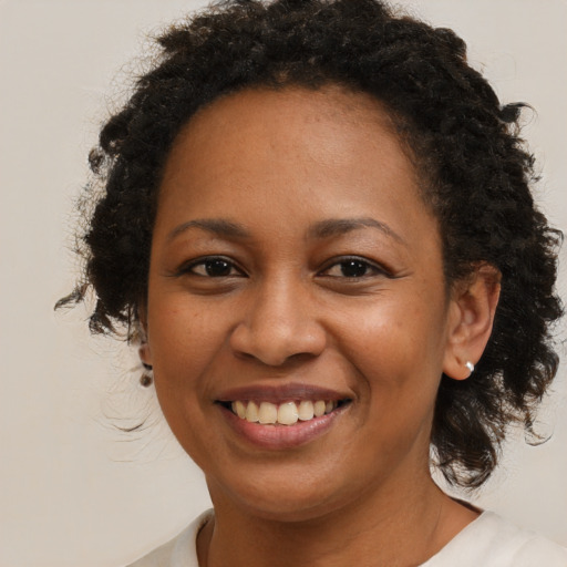 Joyful black young-adult female with medium  brown hair and brown eyes