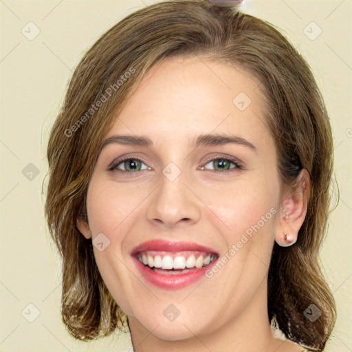 Joyful white young-adult female with medium  brown hair and green eyes