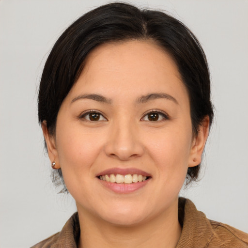 Joyful white young-adult female with medium  brown hair and brown eyes