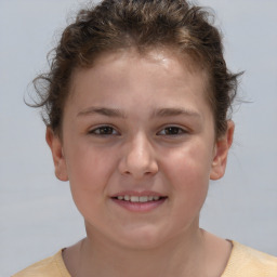 Joyful white child female with short  brown hair and brown eyes