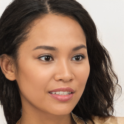 Joyful latino young-adult female with long  brown hair and brown eyes