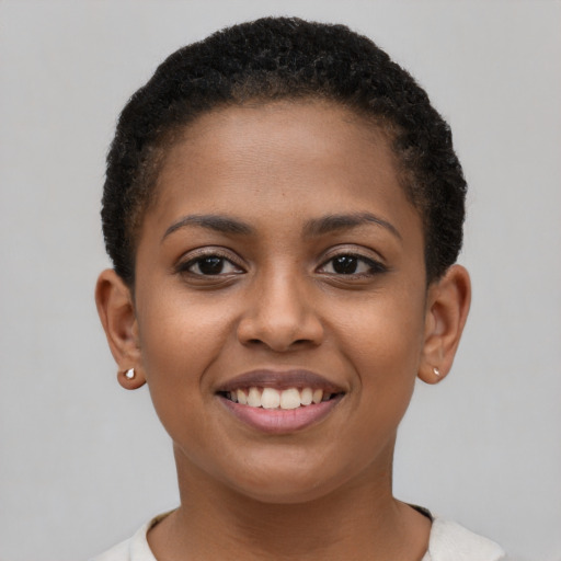 Joyful black young-adult female with short  brown hair and brown eyes