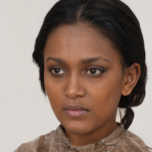 Neutral black young-adult female with medium  brown hair and brown eyes