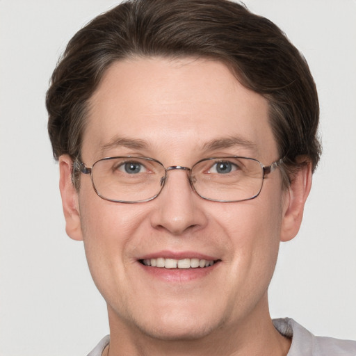 Joyful white adult male with short  brown hair and grey eyes