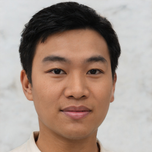 Joyful asian young-adult male with short  black hair and brown eyes