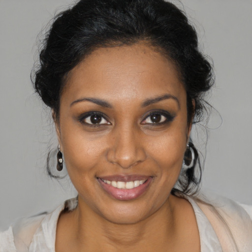 Joyful black young-adult female with medium  brown hair and brown eyes