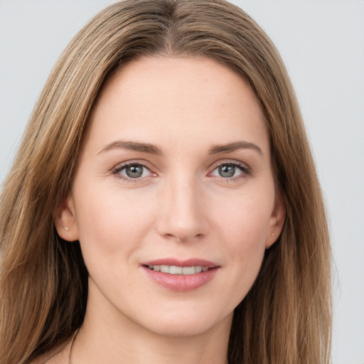 Joyful white young-adult female with long  brown hair and grey eyes