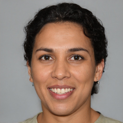 Joyful latino young-adult female with short  brown hair and brown eyes