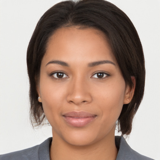 Joyful latino young-adult female with medium  brown hair and brown eyes