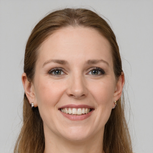 Joyful white young-adult female with long  brown hair and grey eyes