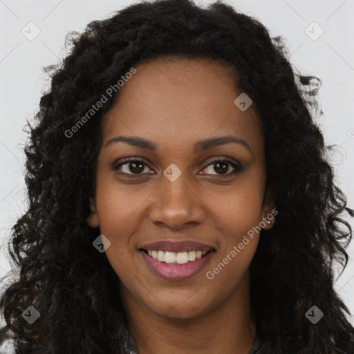 Joyful black young-adult female with long  brown hair and brown eyes