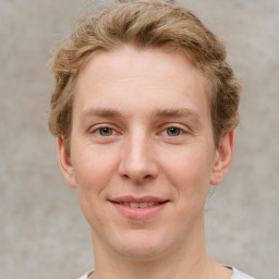 Joyful white adult male with short  brown hair and grey eyes