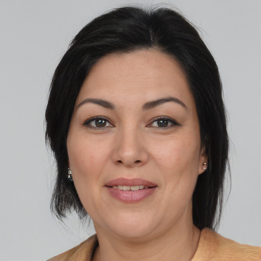 Joyful white adult female with medium  brown hair and brown eyes