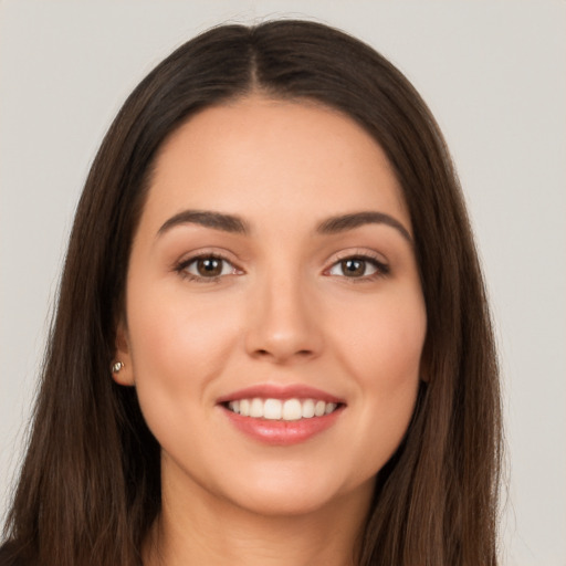 Joyful white young-adult female with long  brown hair and brown eyes