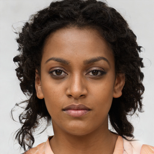 Neutral black young-adult female with long  brown hair and brown eyes