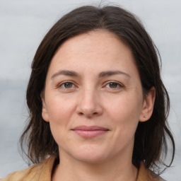 Joyful white adult female with medium  brown hair and brown eyes