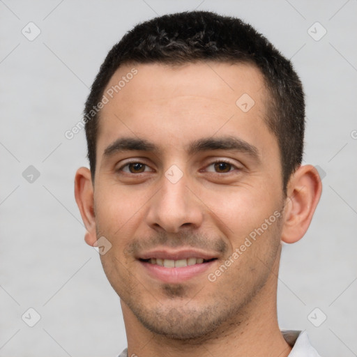 Joyful white young-adult male with short  brown hair and brown eyes