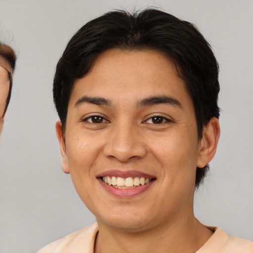 Joyful asian young-adult female with short  brown hair and brown eyes