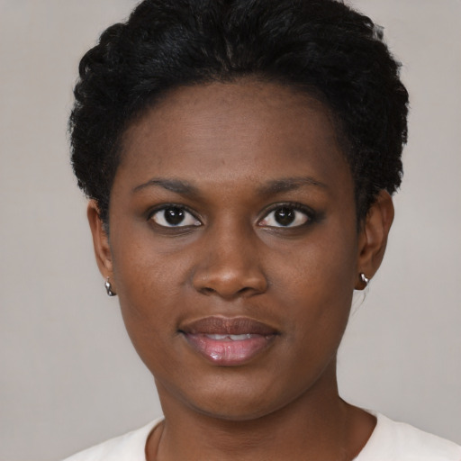 Joyful black young-adult female with short  brown hair and brown eyes