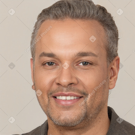 Joyful white adult male with short  brown hair and brown eyes