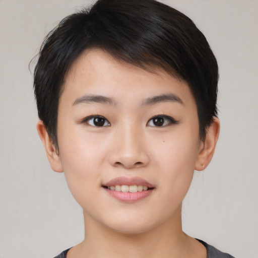 Joyful asian young-adult female with short  brown hair and brown eyes