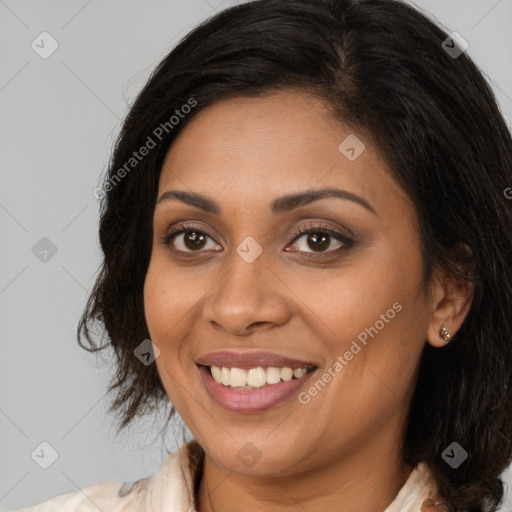 Joyful black young-adult female with medium  brown hair and brown eyes