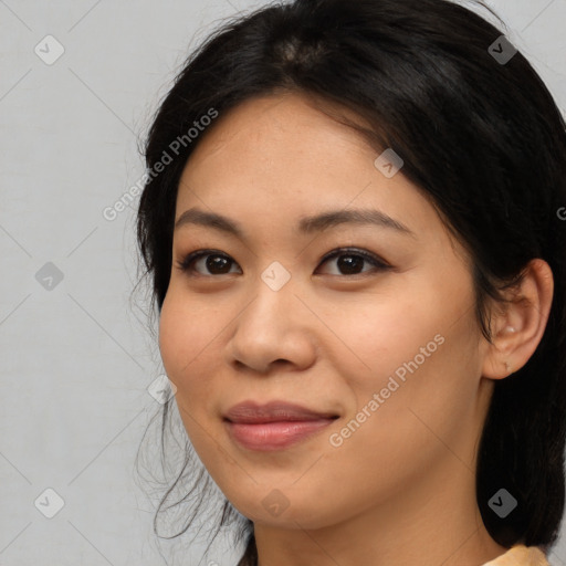 Joyful asian young-adult female with medium  black hair and brown eyes