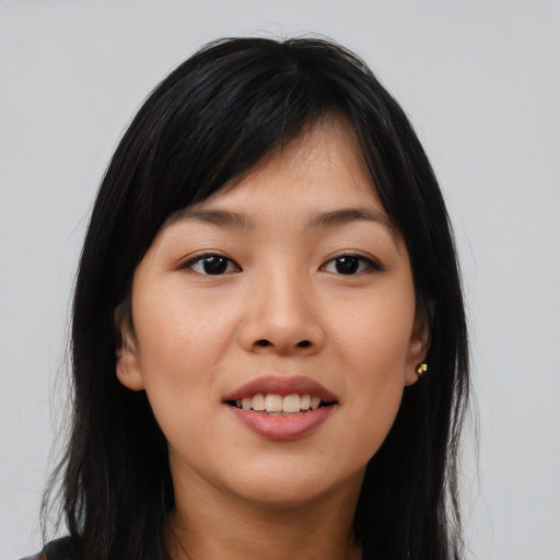 Joyful asian young-adult female with long  black hair and brown eyes
