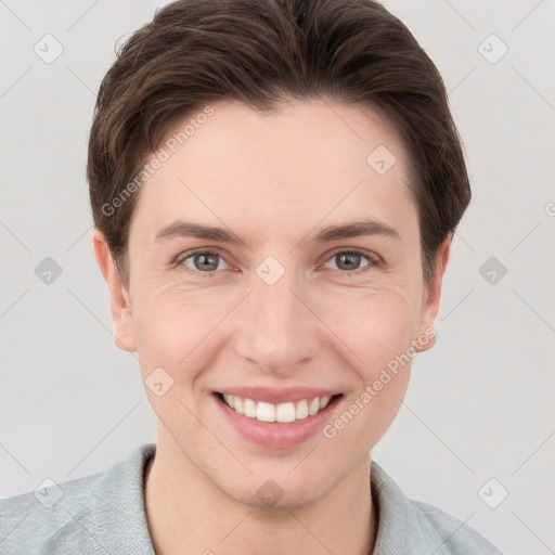 Joyful white young-adult female with short  brown hair and grey eyes