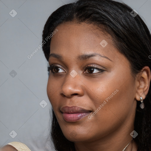 Joyful black young-adult female with long  brown hair and brown eyes