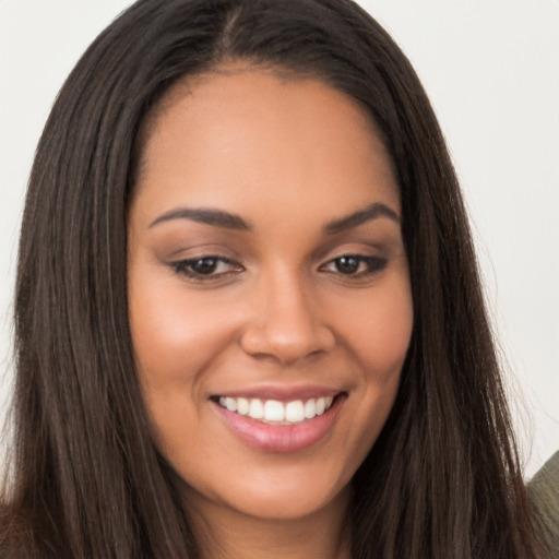 Joyful latino young-adult female with long  brown hair and brown eyes