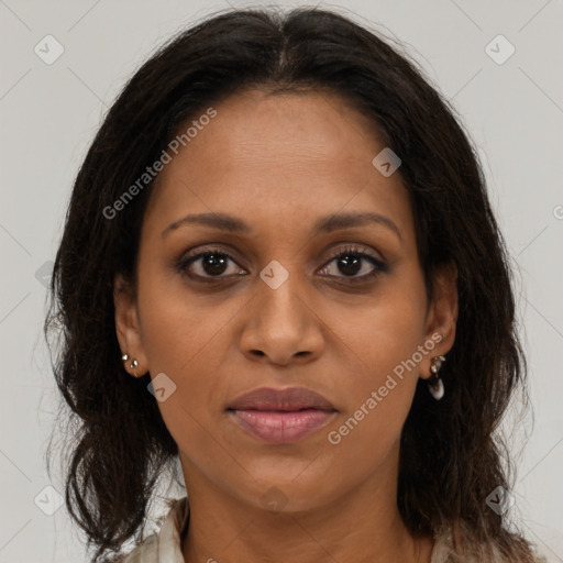 Joyful black young-adult female with long  brown hair and brown eyes