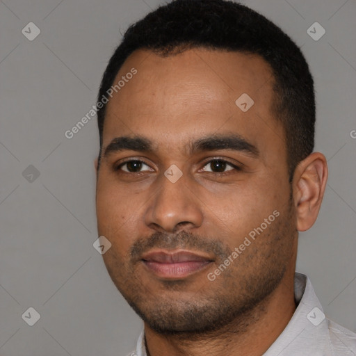 Joyful black young-adult male with short  black hair and brown eyes