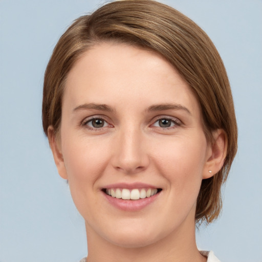 Joyful white young-adult female with medium  brown hair and grey eyes