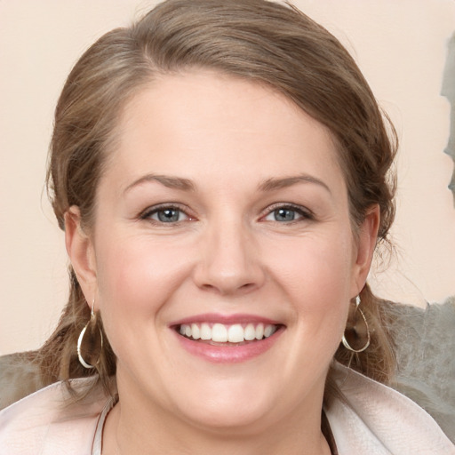 Joyful white young-adult female with medium  brown hair and grey eyes